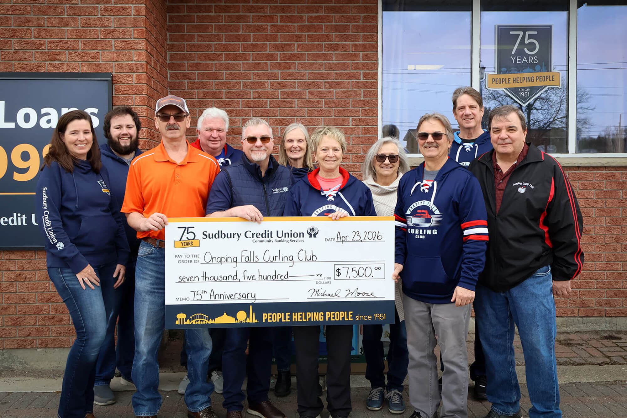 SCU staff present a cheque for $7,500 to the Onaping Falls Curling Club